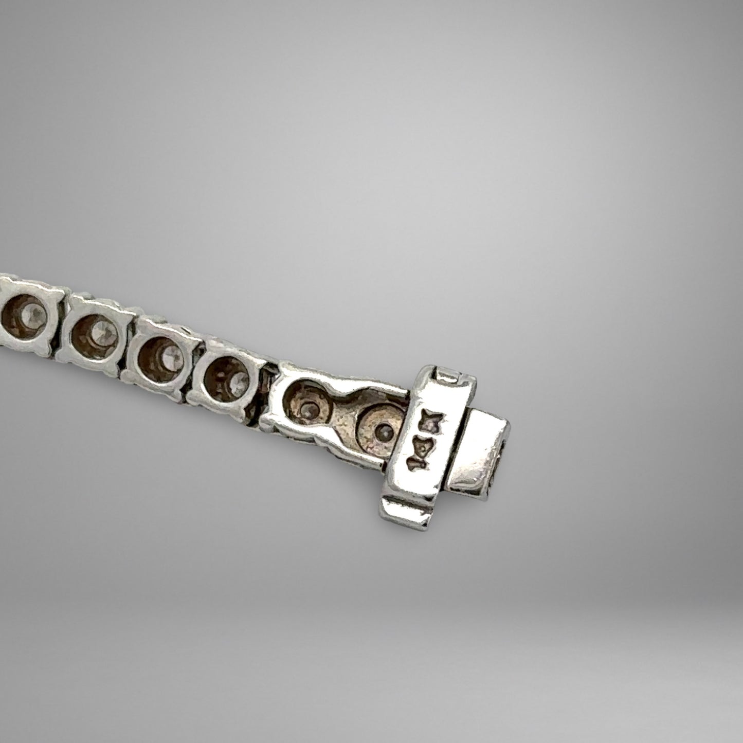 Close-up of a silver bracelet on a gray background