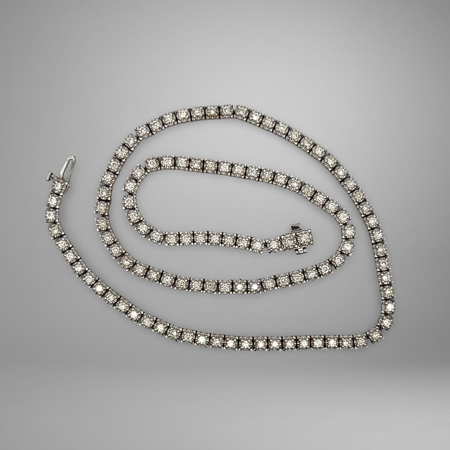 Diamond tennis necklace on a gray background