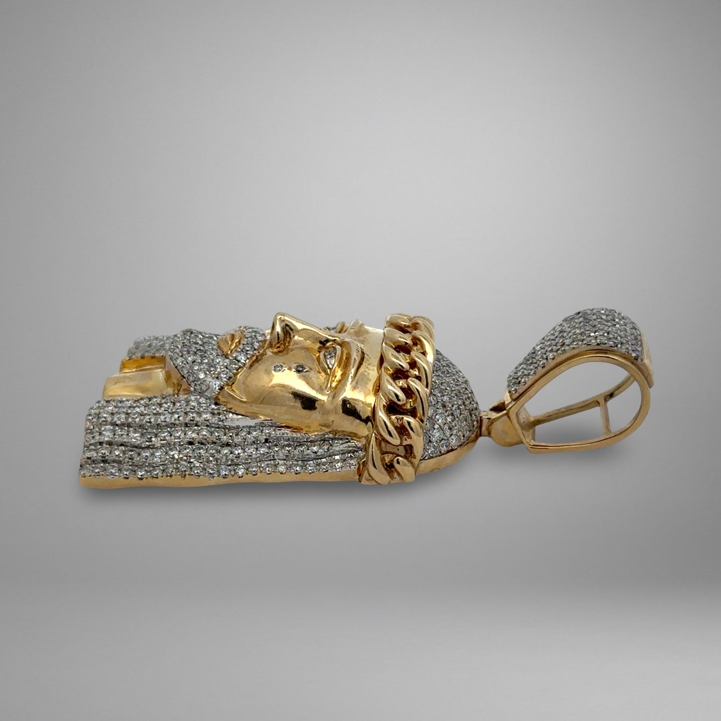 Gold and diamond-encrusted headpiece on a gray background