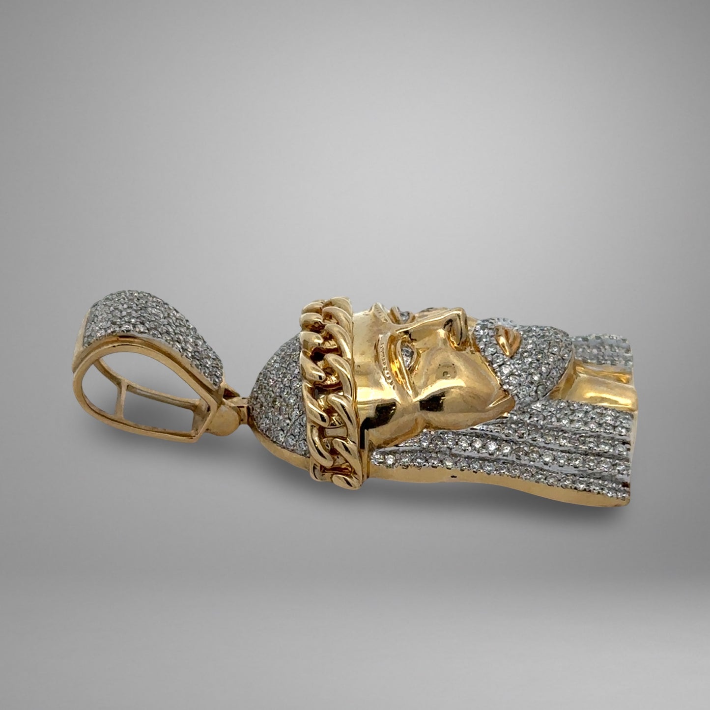 Gold pendant on a gray background