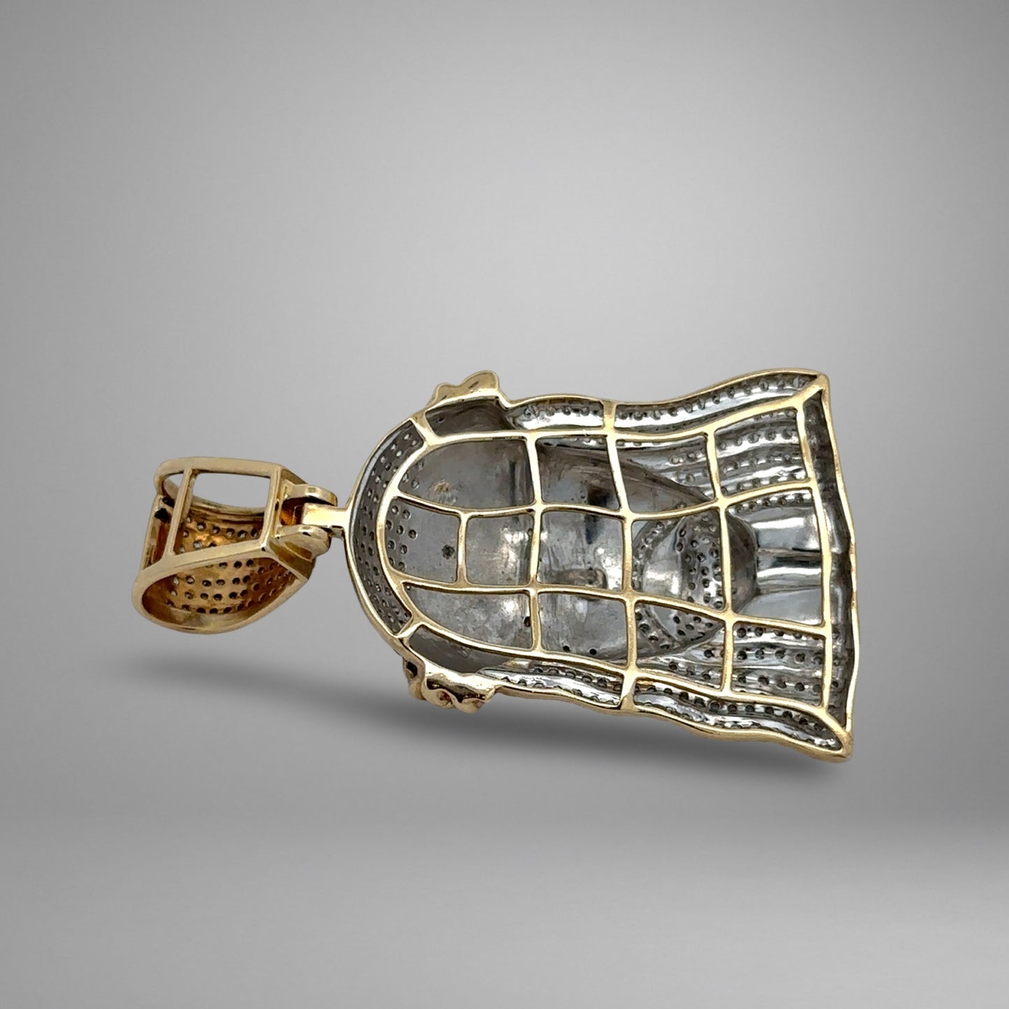 Gold pendant on a gray background