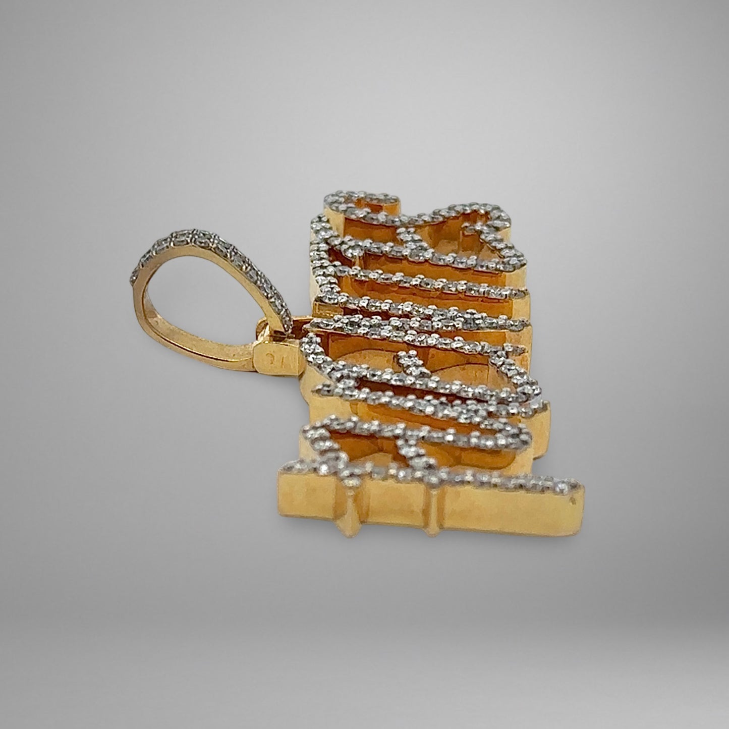 Gold pendant on a gray background
