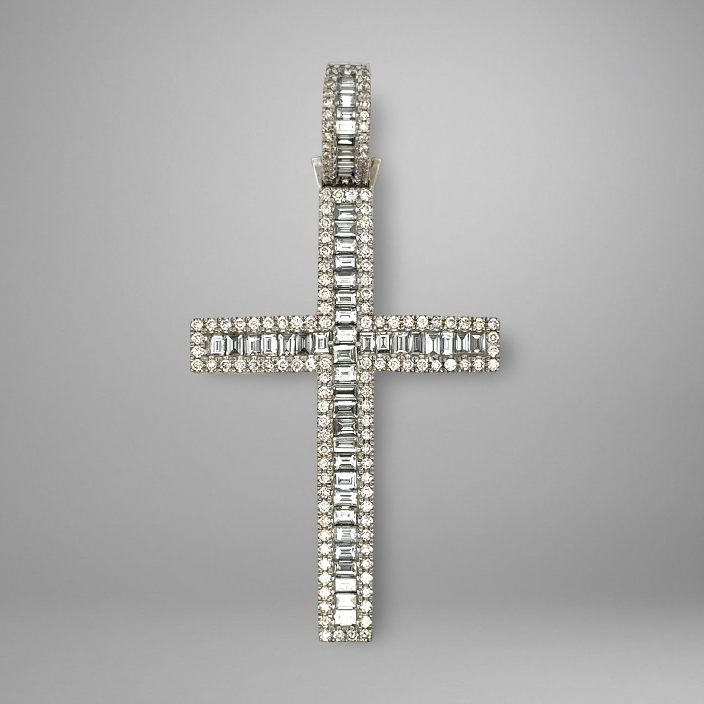 Diamond cross pendant on a gray background