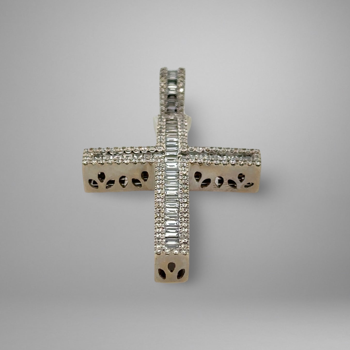 Diamond cross pendant on a gray background