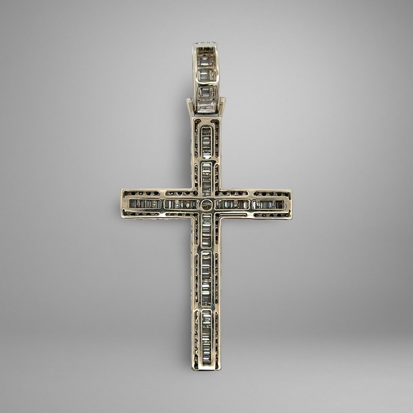 Back of diamond cross pendant on a gray background