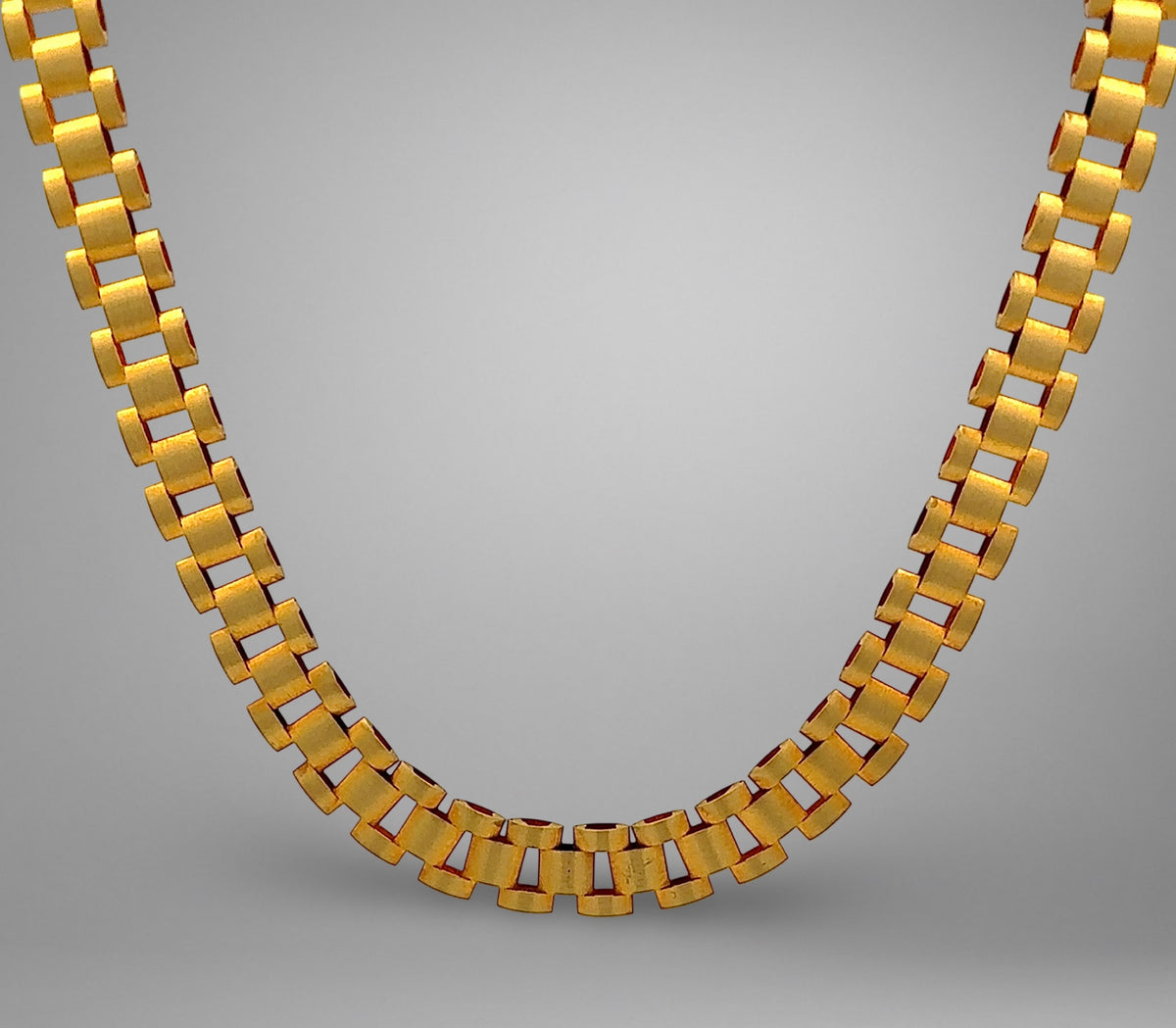 Gold necklace on a gray background