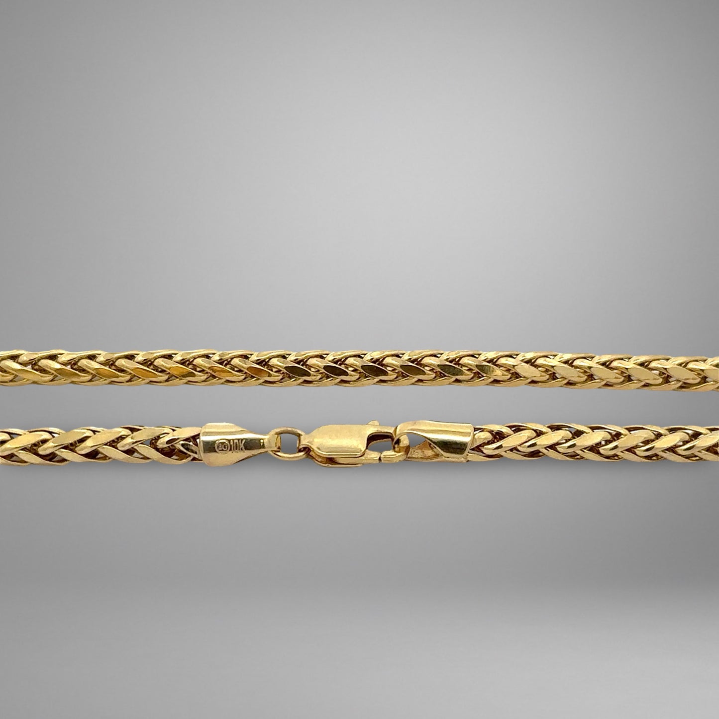 Gold chain on a gray background