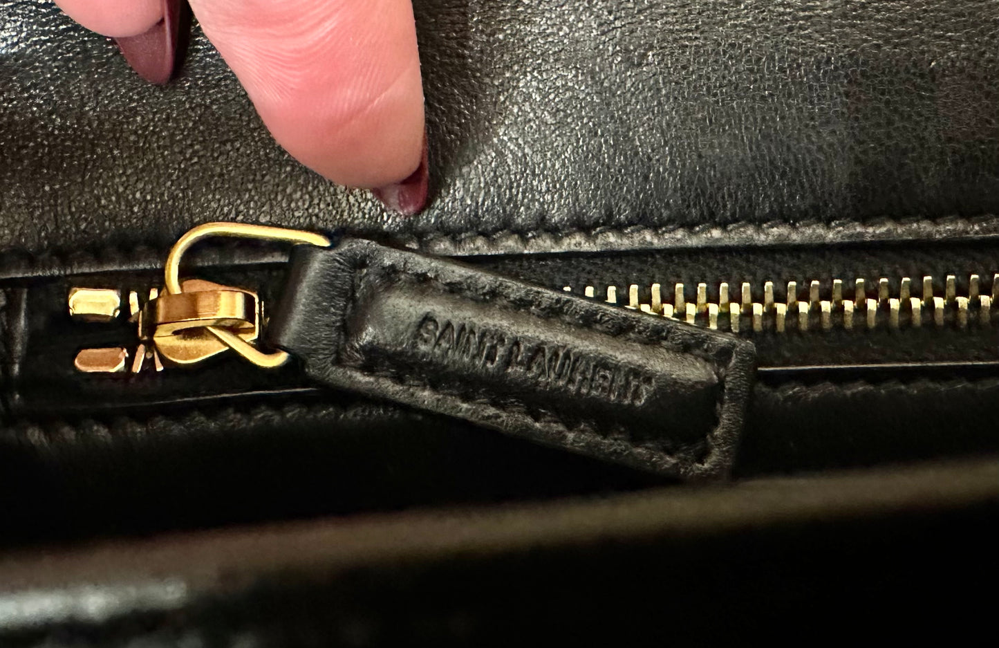 Close up of zipper with Saint Laurent embossed