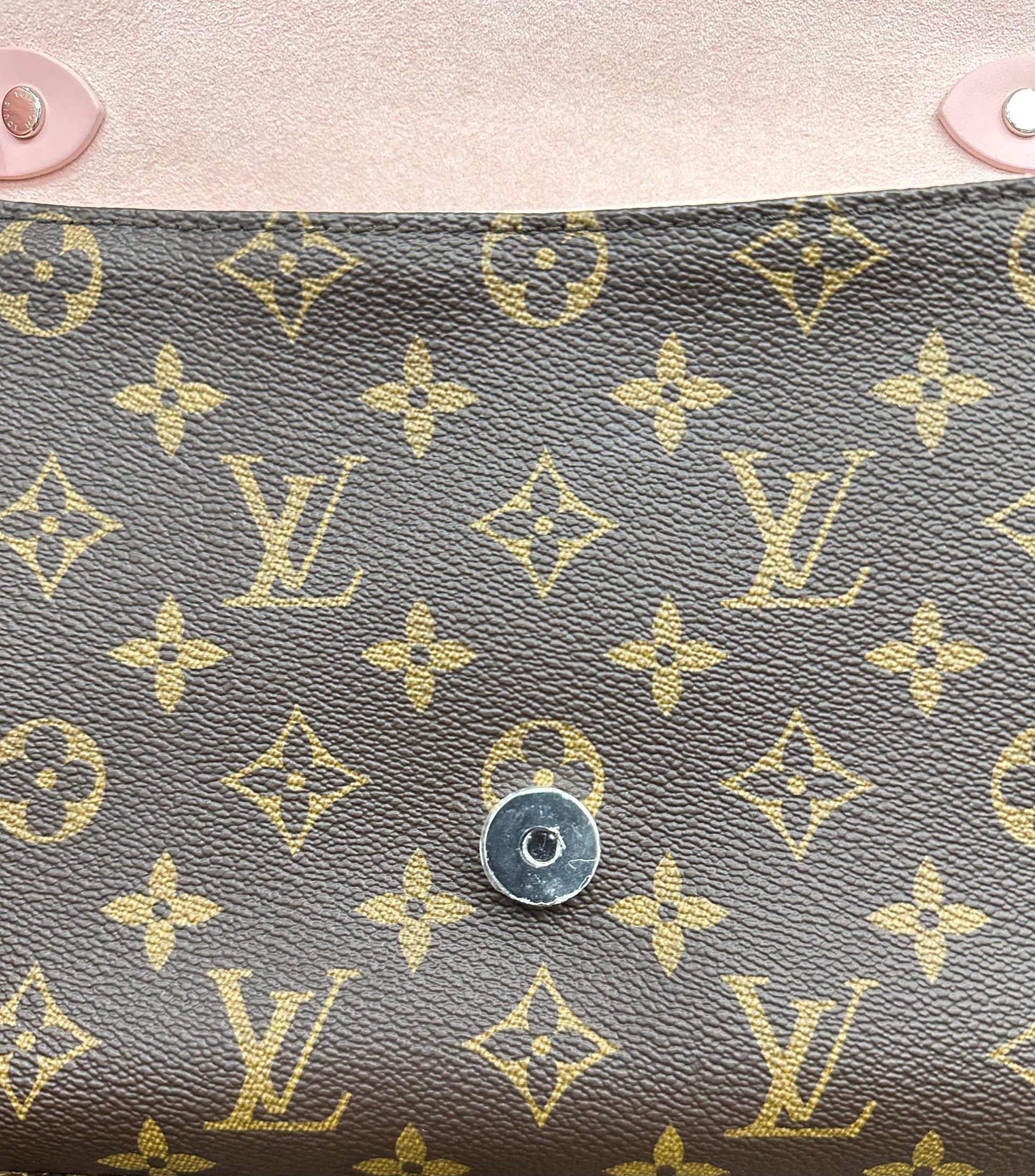 Close up of front of outside of bag under the flap with silver hardware fasten closure
