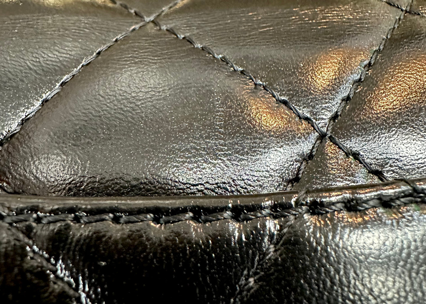 Close up of black leather with very light scuff mark a little to the right of the center 