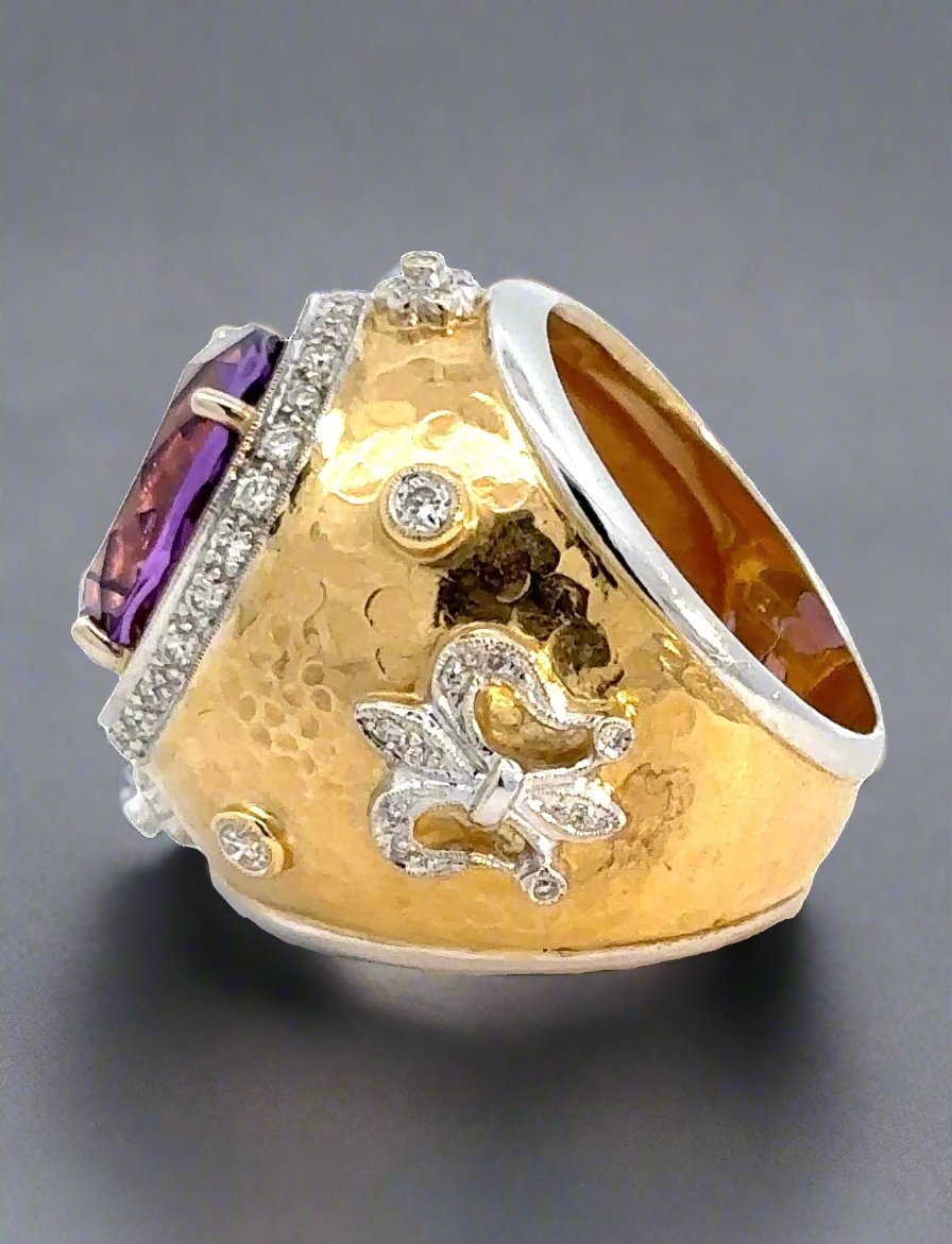 The side of the amethyst ring. Shows the 18K yellow gold and small diamonds. Some scratches shown.