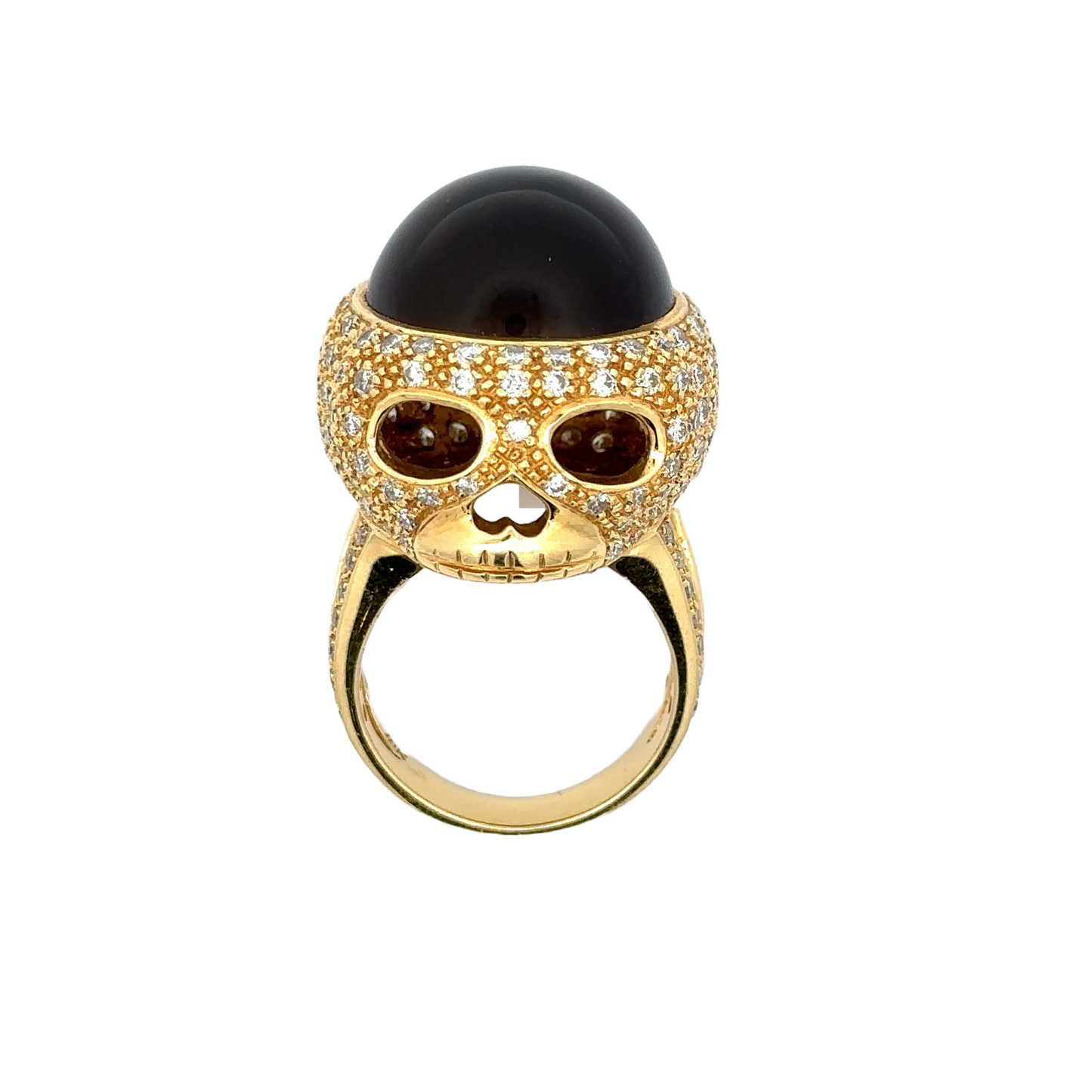 18K yellow gold cat's eye diamond skull ring. Shows the skull face of the ring. Some scratches on the band.