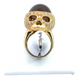 The skull ring on a ring stand to show what it would look like on the finger.