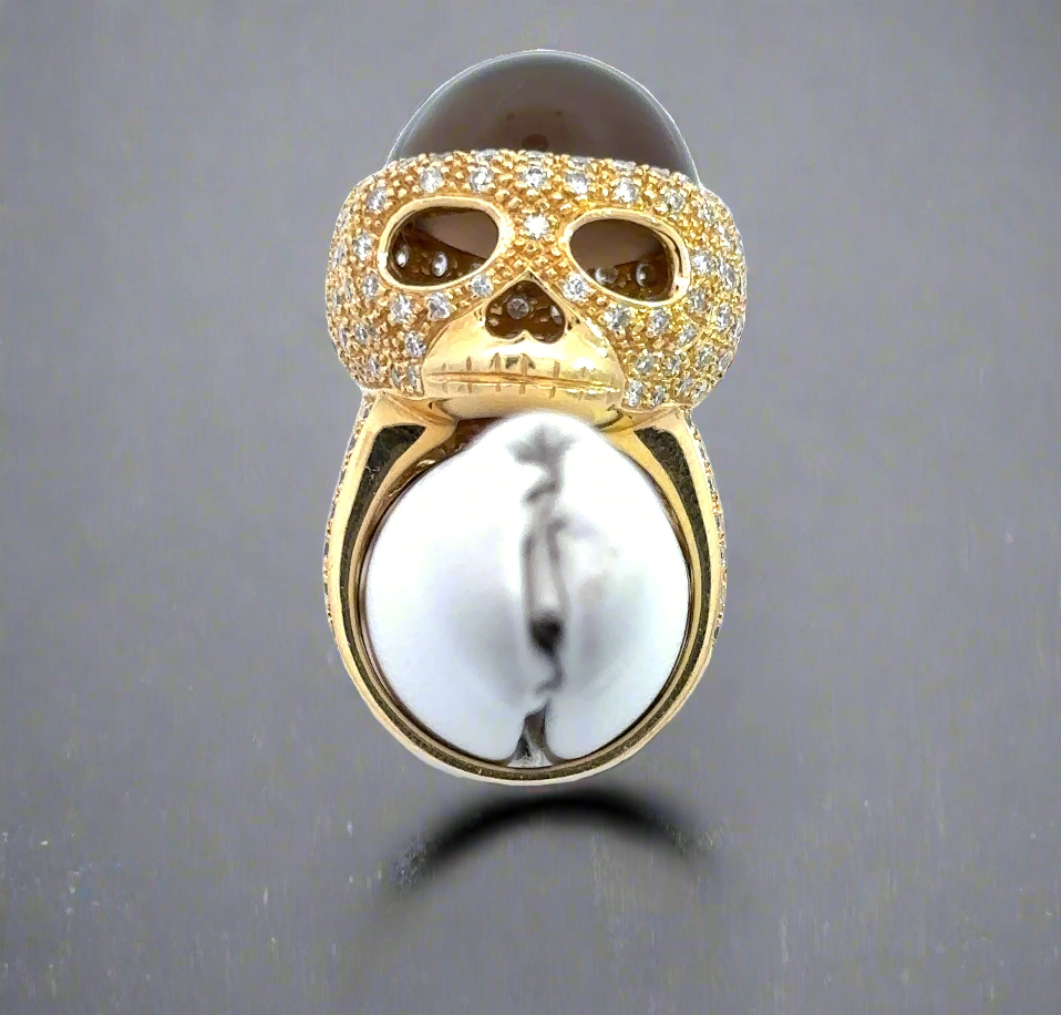 The skull ring on a ring stand to show what it would look like on the finger.