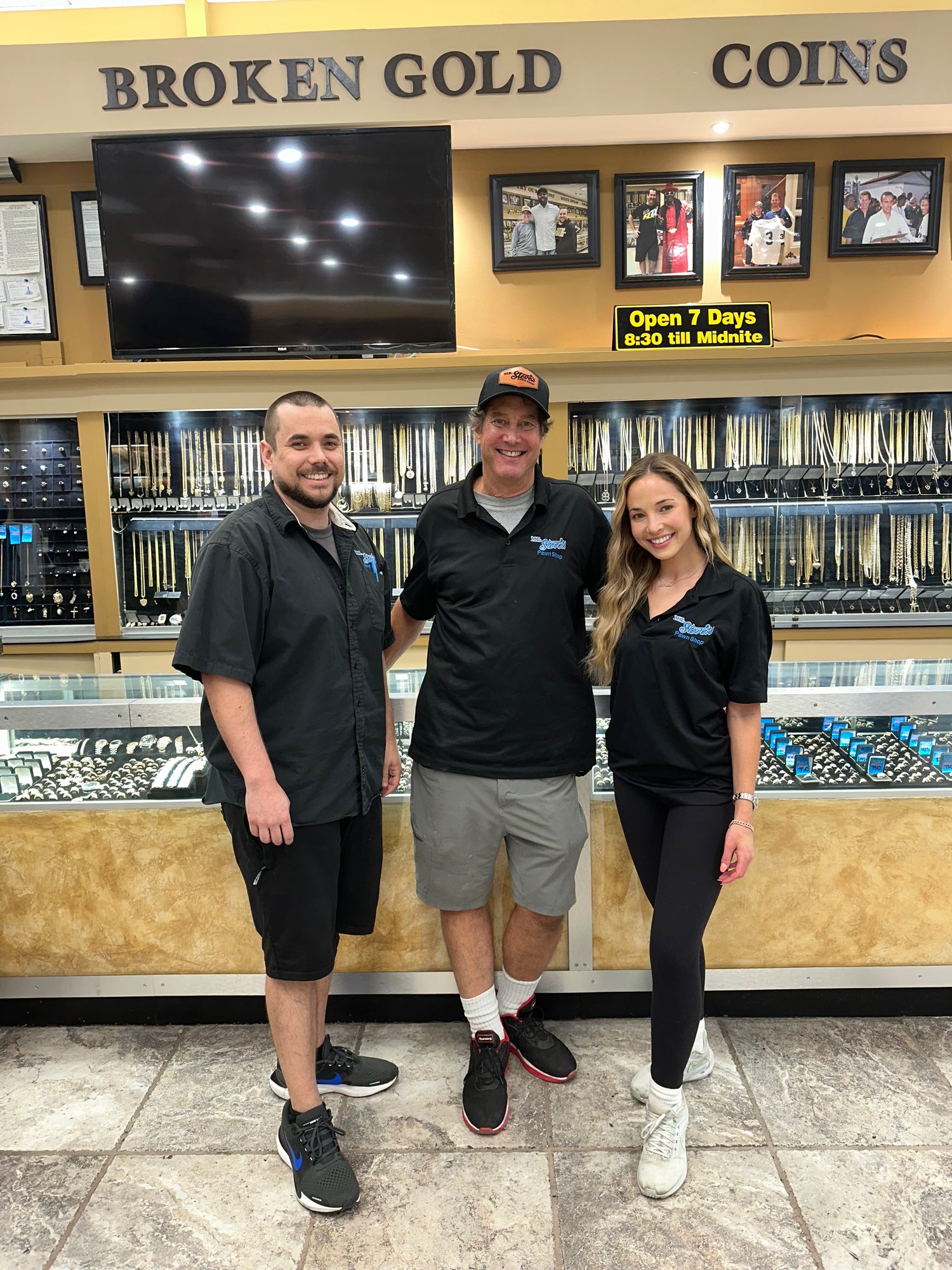 A son, father, and daughter smiling wearing Mr. Steve's Pawn Shop polos.