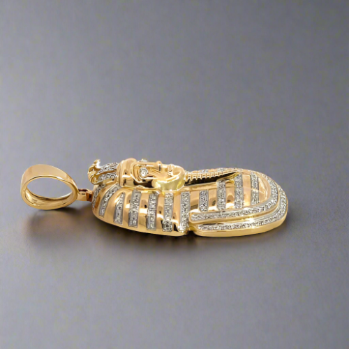 Side of diamond pharaoh pendant with round bail. Some scratches on gold
