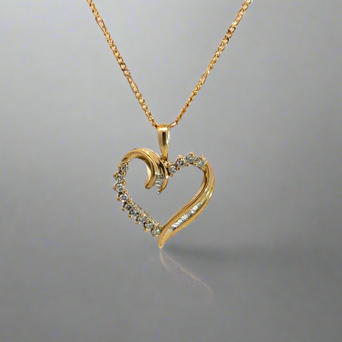 front of yellow gold diamond heart necklace with open gold