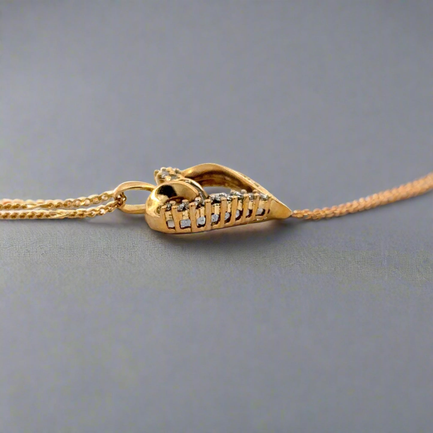 side of yellow gold heart with round bail