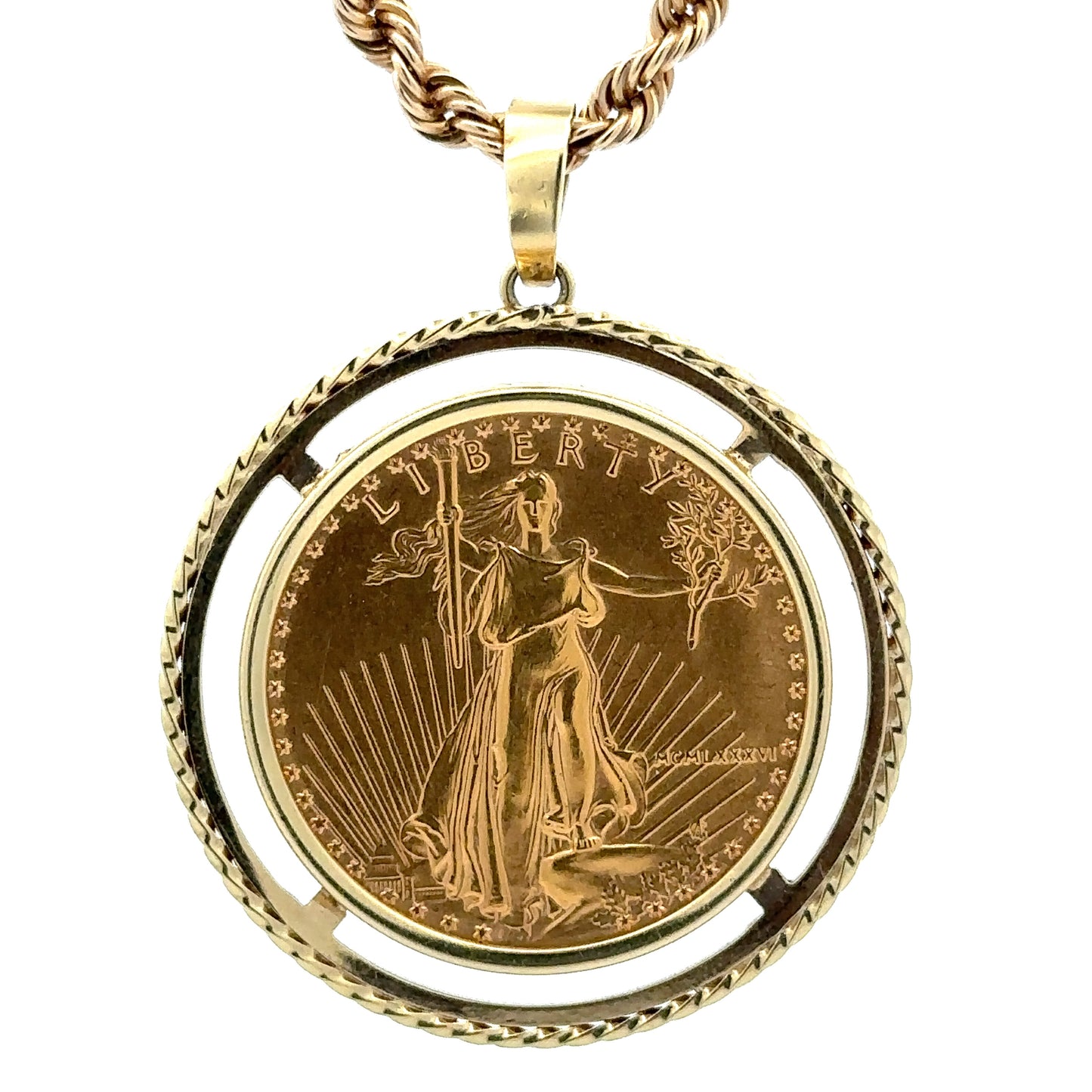 close up of coin pendant with 1986 in roman numerals