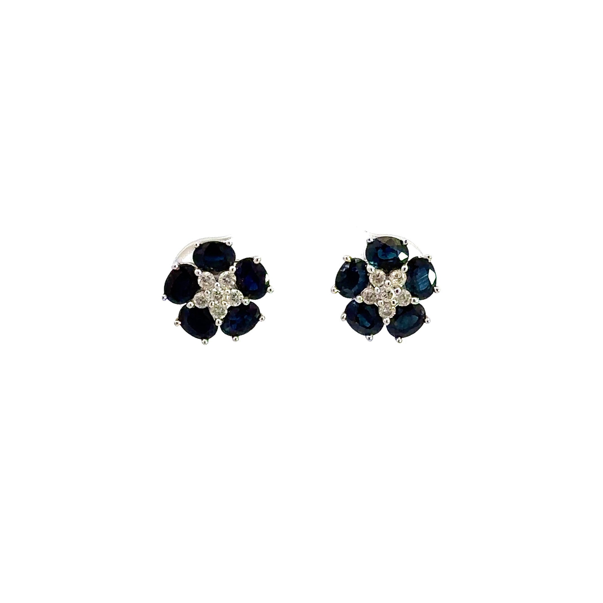 Front of diamond and blue gemstone earrings with 6 small round brilliant diamonds in the center and 5 oval shaped dark blue gemstones around them.