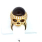 The top of the skull ring. You can see the brown cat's eye gemstone and the skull face. Small scratches on the band.