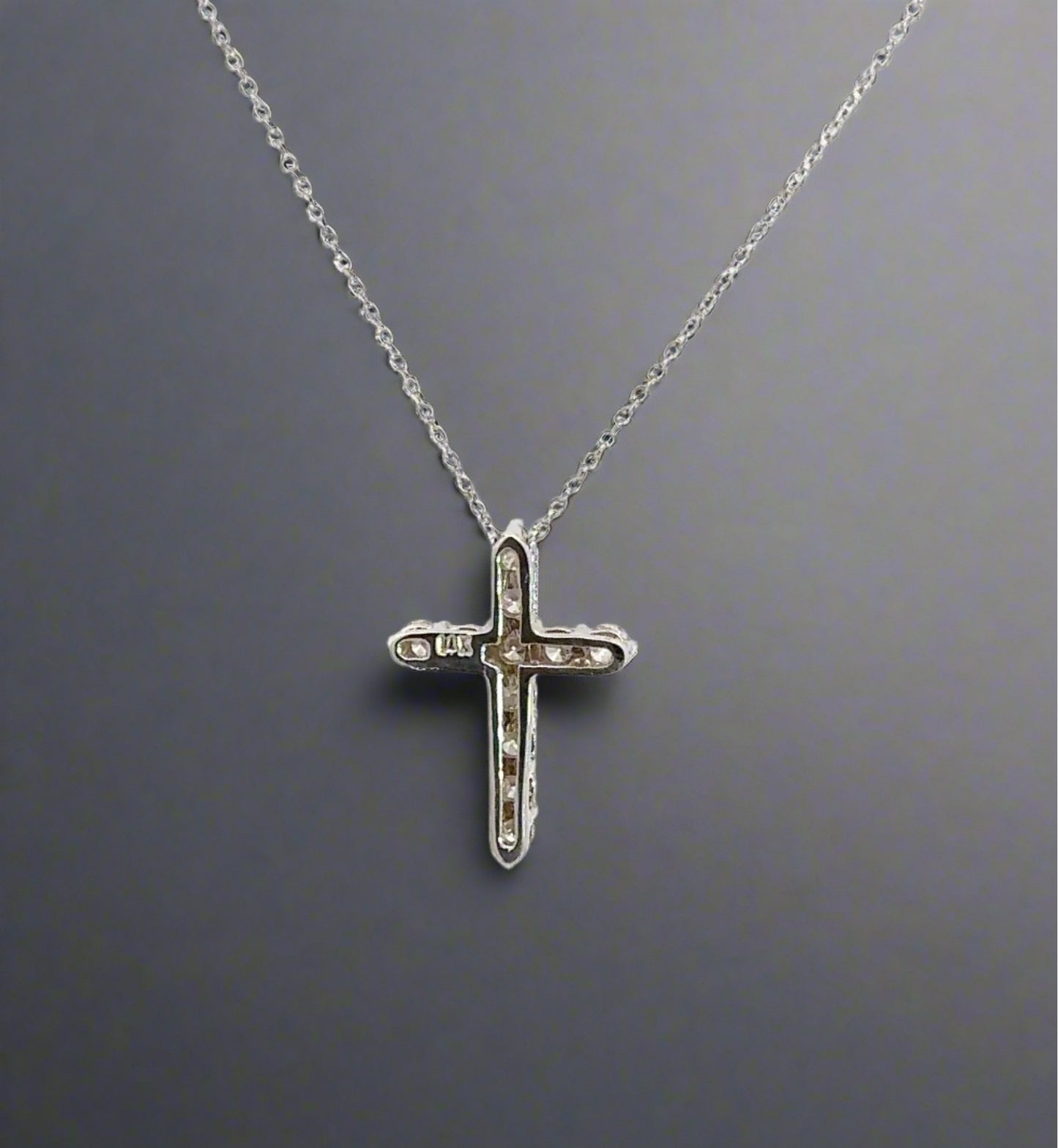 back of white gold cross with a 14K stamp