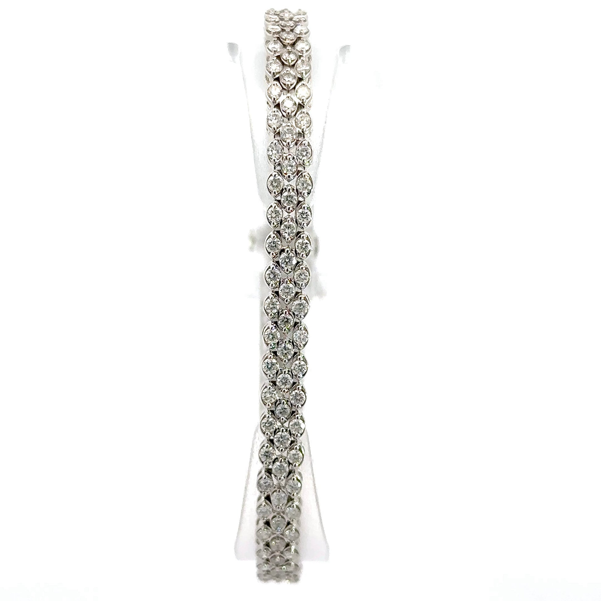 Front of diamond tennis bracelet with 3 rows of round diamonds throughout bracelet