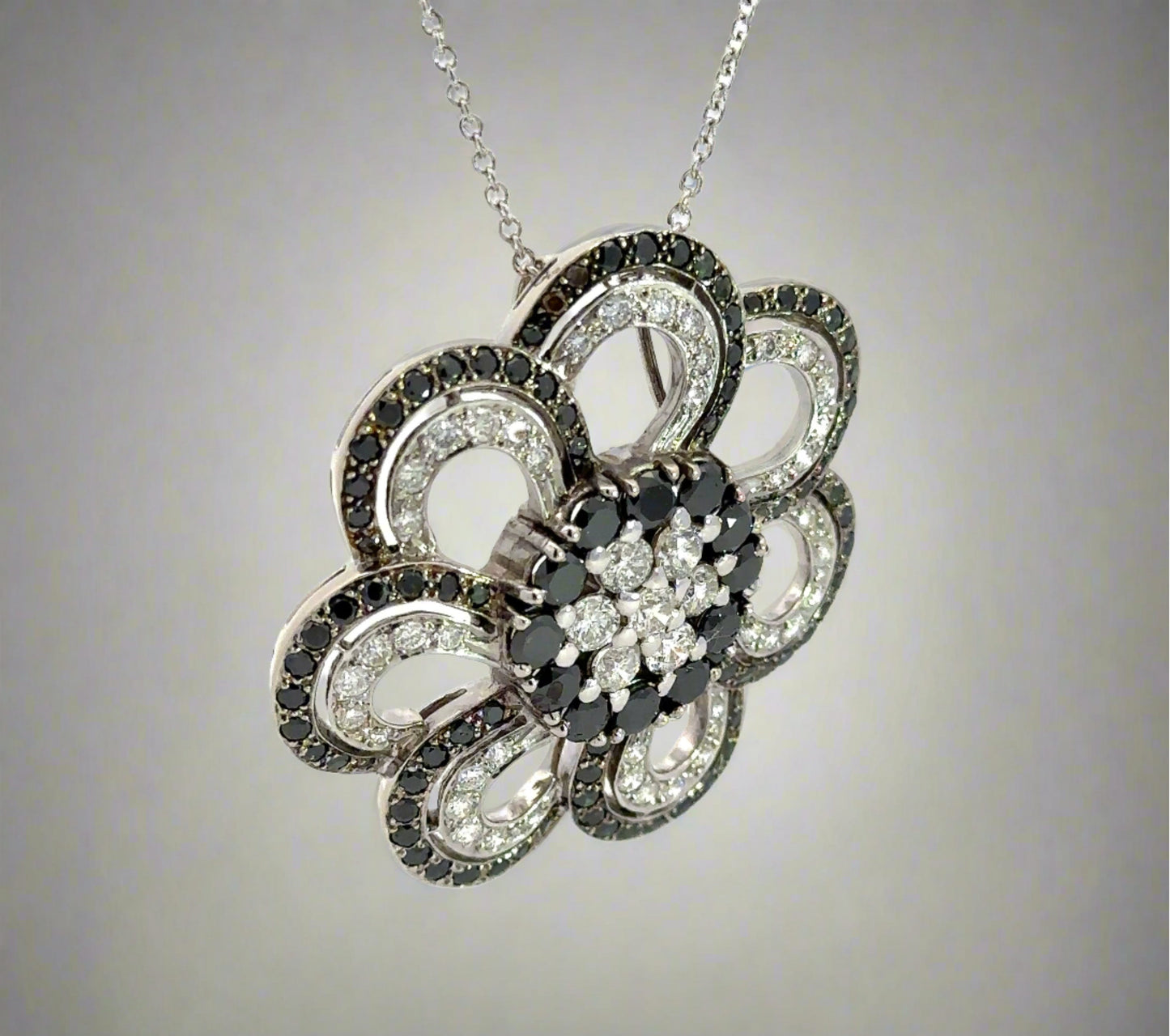 diagonal view of black and white diamond flower necklace