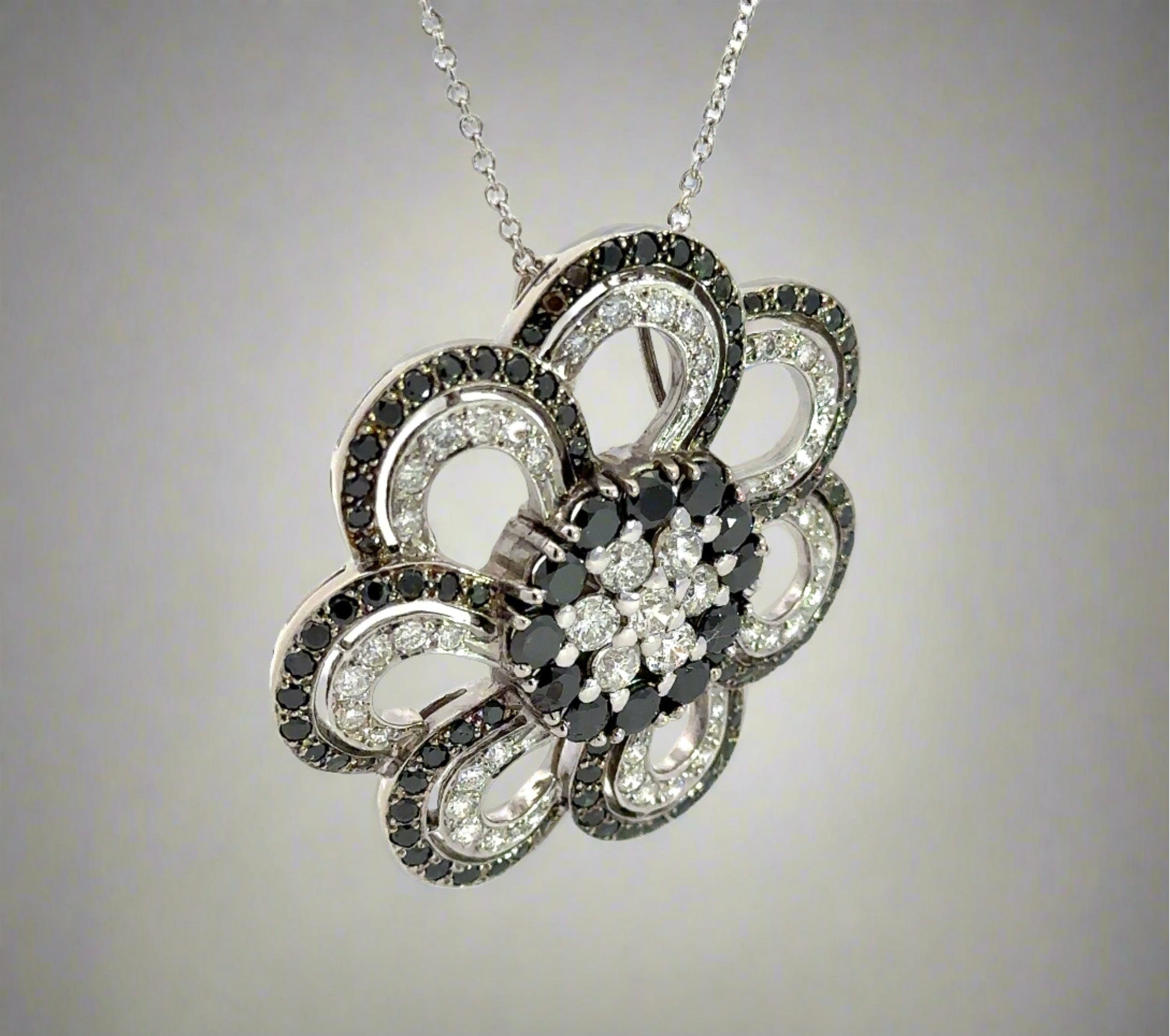 diagonal view of black and white diamond flower necklace