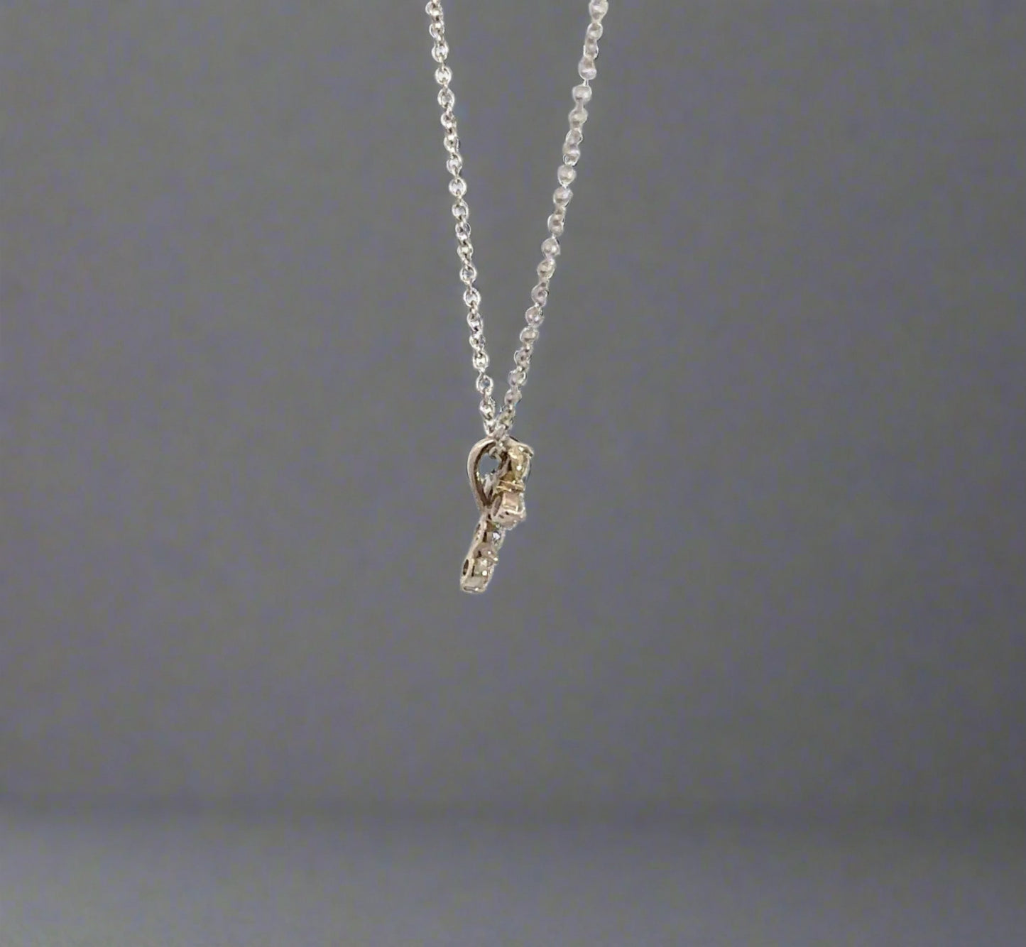 side of diamond cross necklace with attached bail