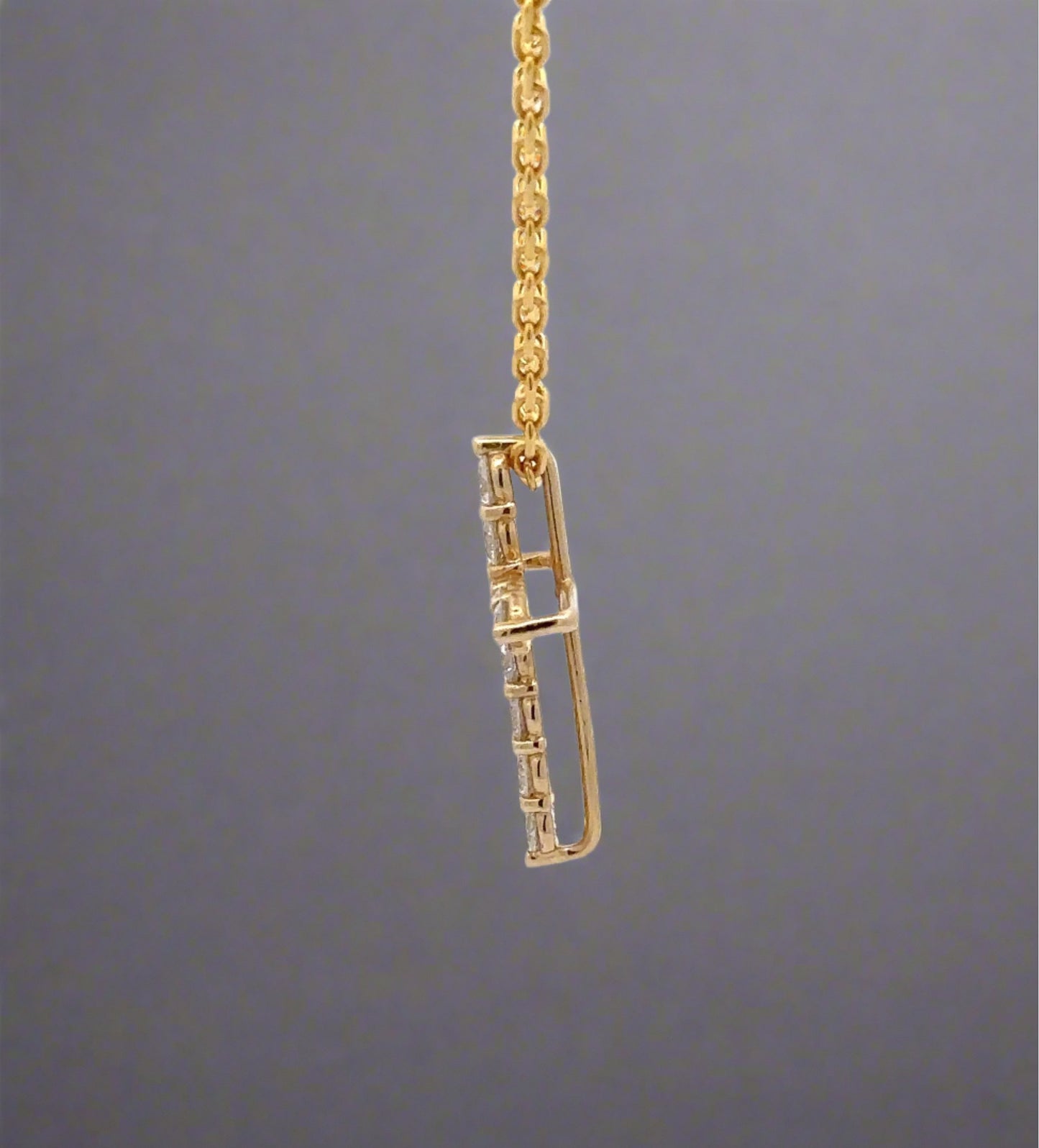 side of yellow gold cross necklace
