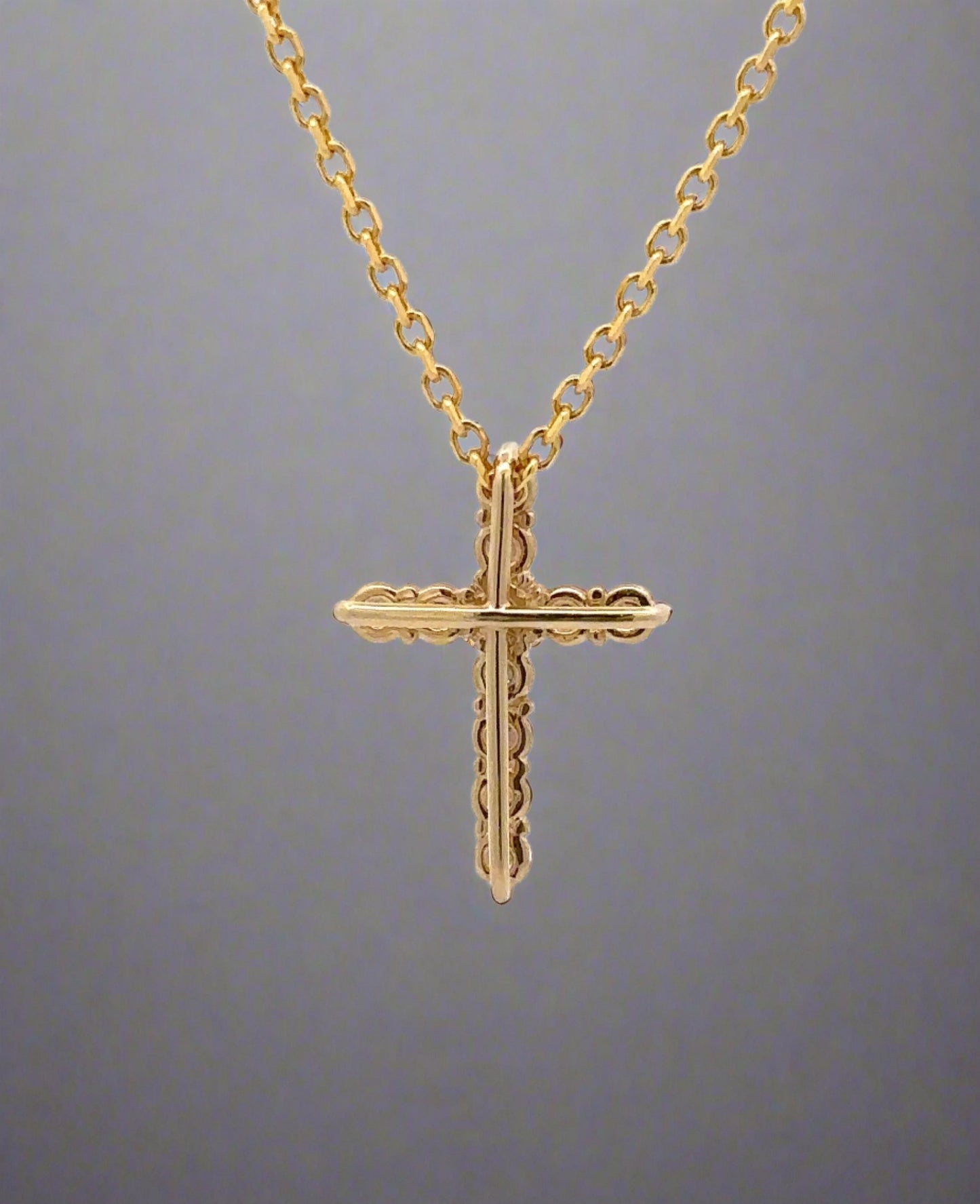 back of yellow gold cross necklace