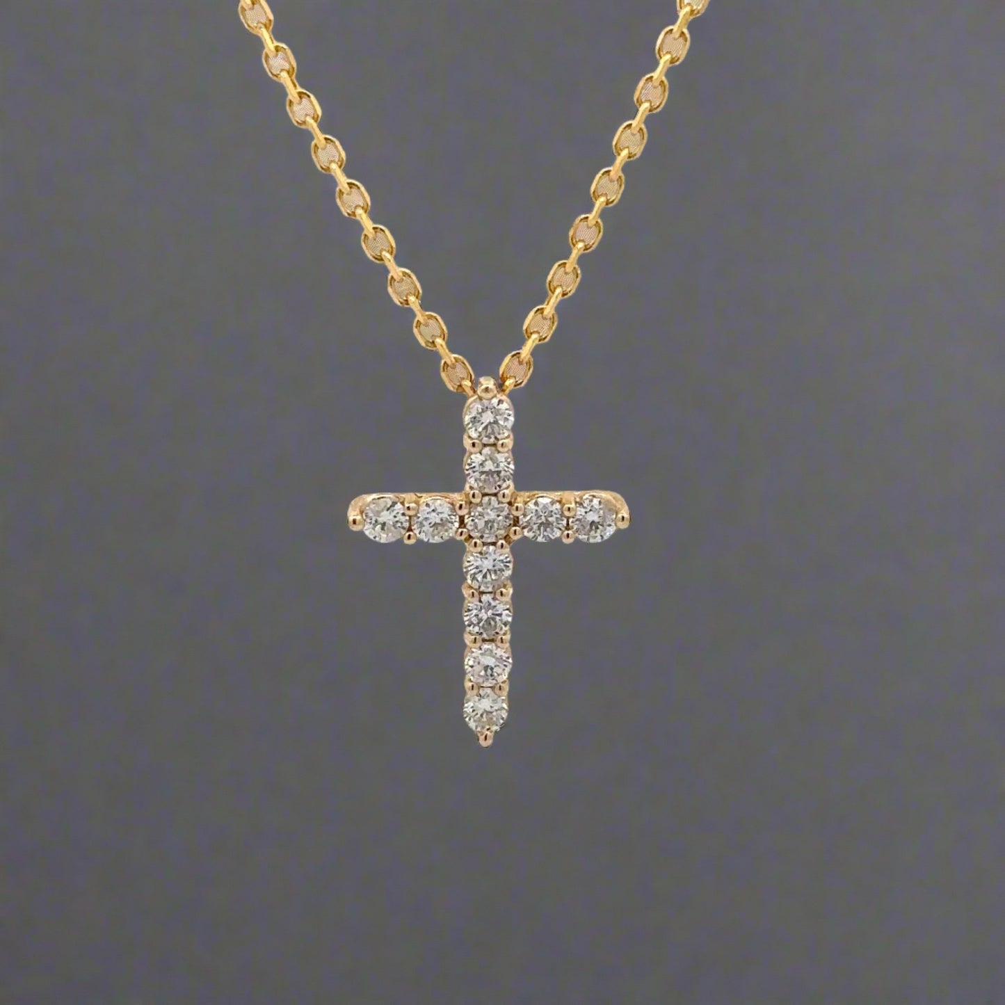 front of diamond cross necklace with 11 round diamonds