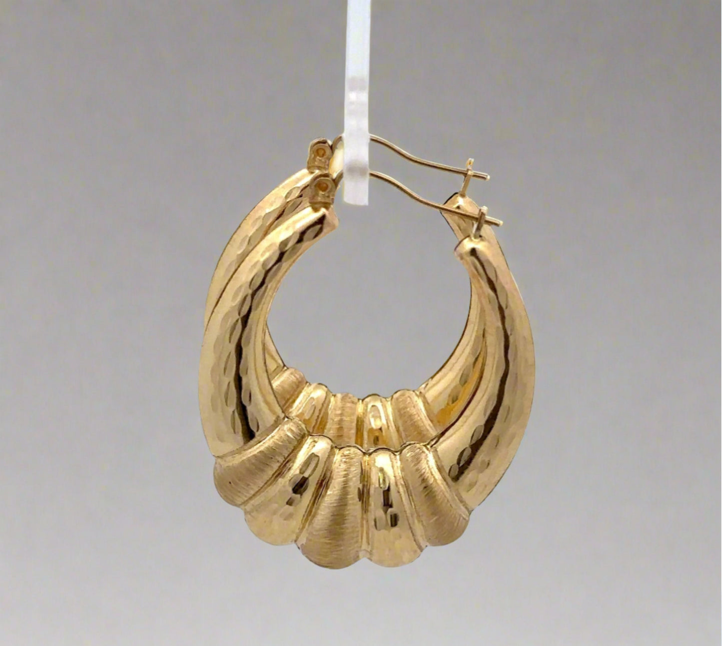 side view of yellow gold shrimp hoops