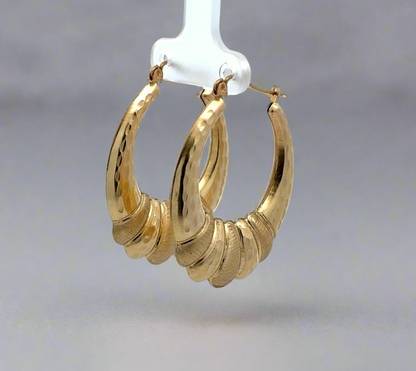 diagonal view of yellow gold shrimp hoops