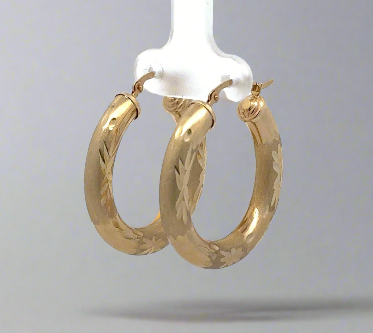 Diagonal view of yellow gold hoops