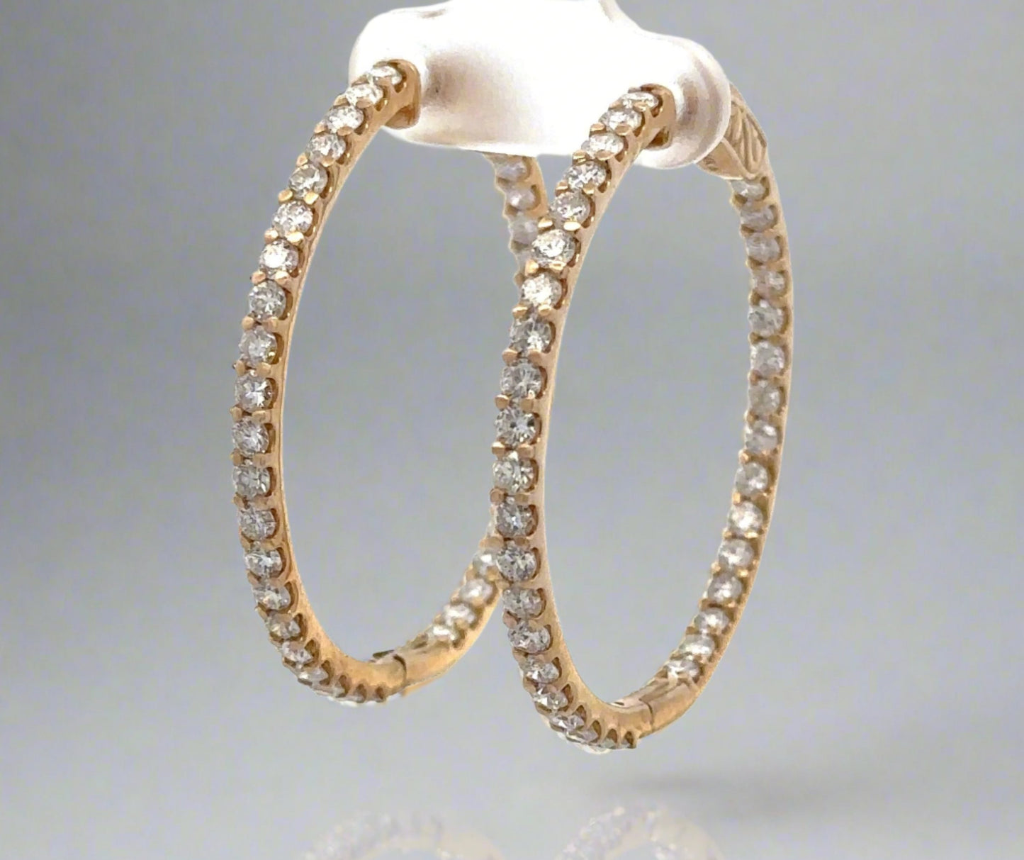 Diagonal view of yellow gold diamond hoops