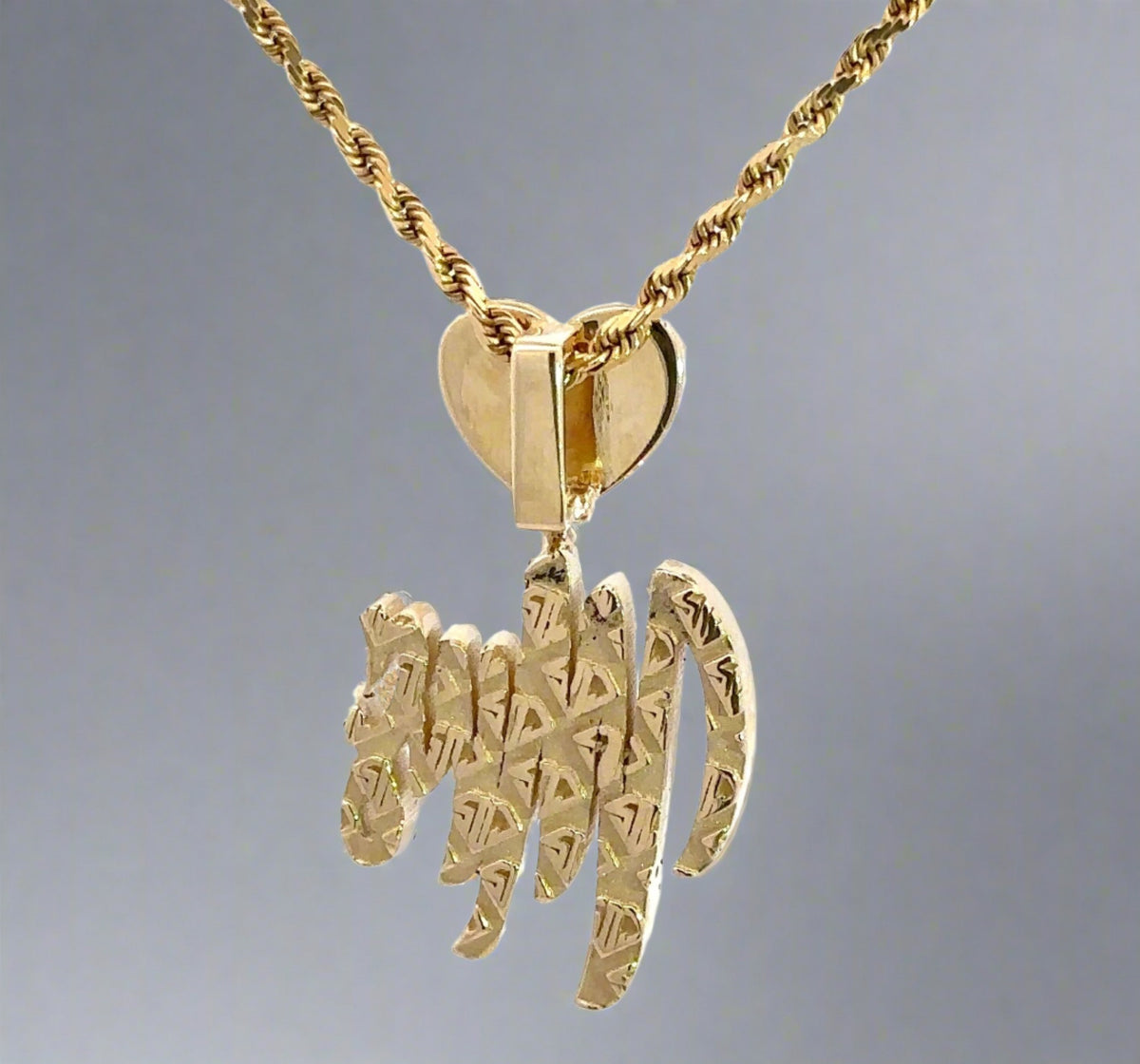 Back of yellow gold Mrs. pendant with diamond design on back