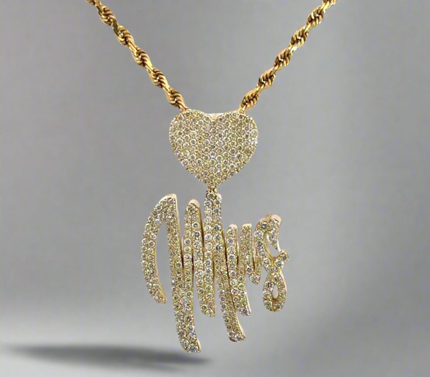 Front of yellow gold diamond Mrs. pendant with a heart and rope chain