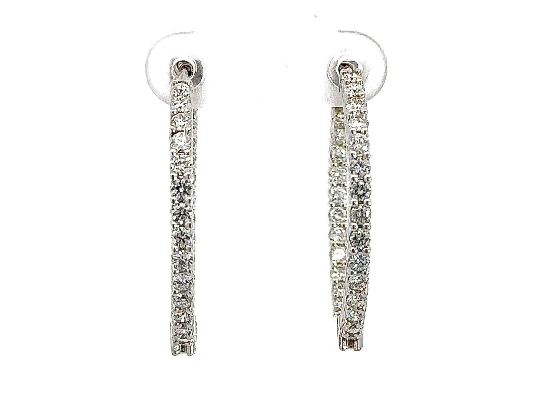 Front of white gold diamond hoop earrings with round diamonds on front