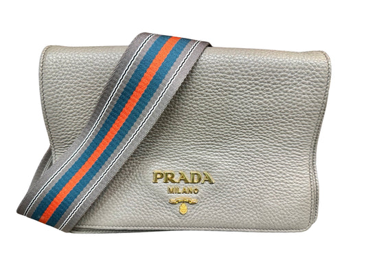 Front of grey Prada with green and red strap