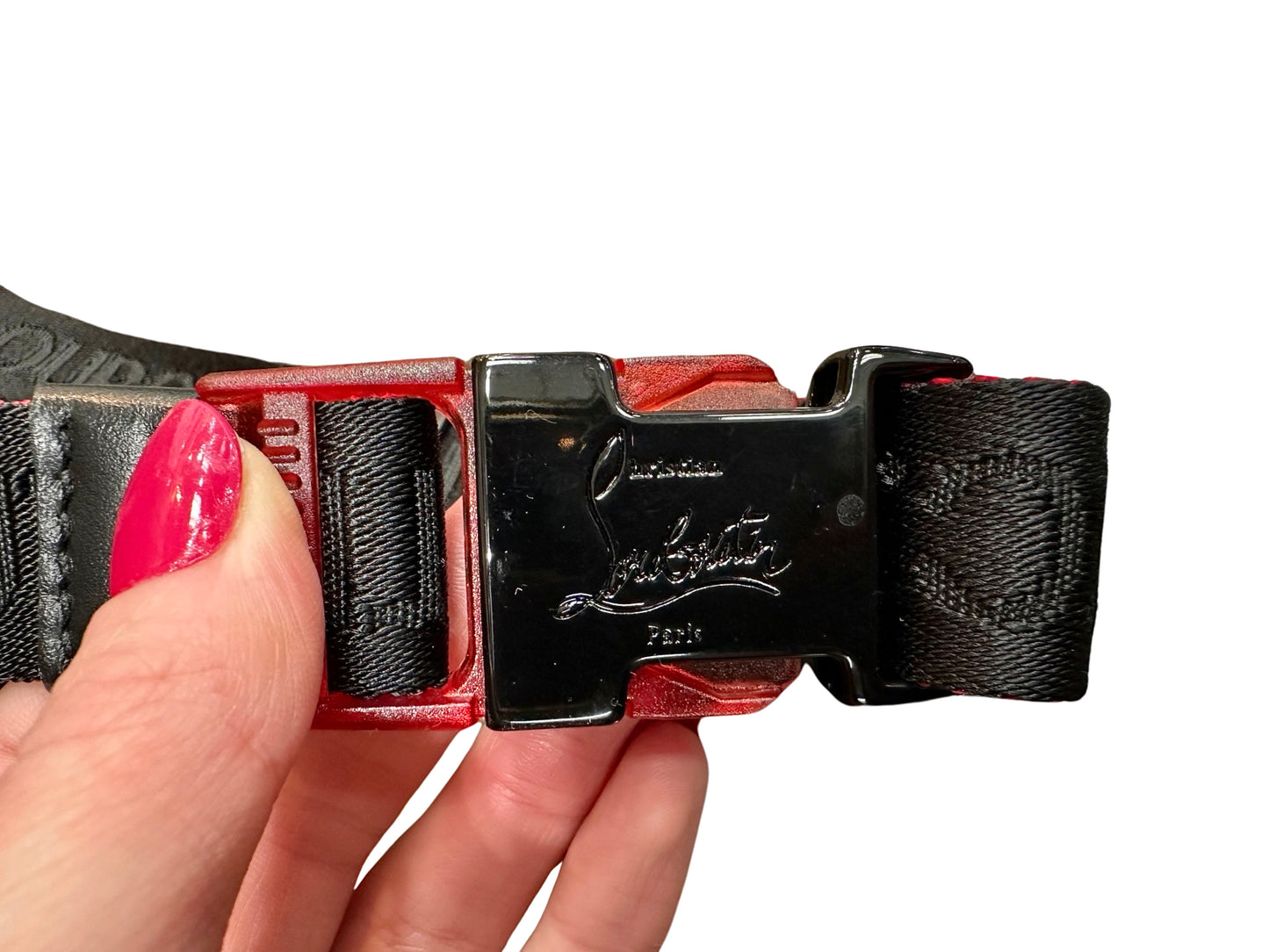 Black belt buckle with Christian Louboutin on it
