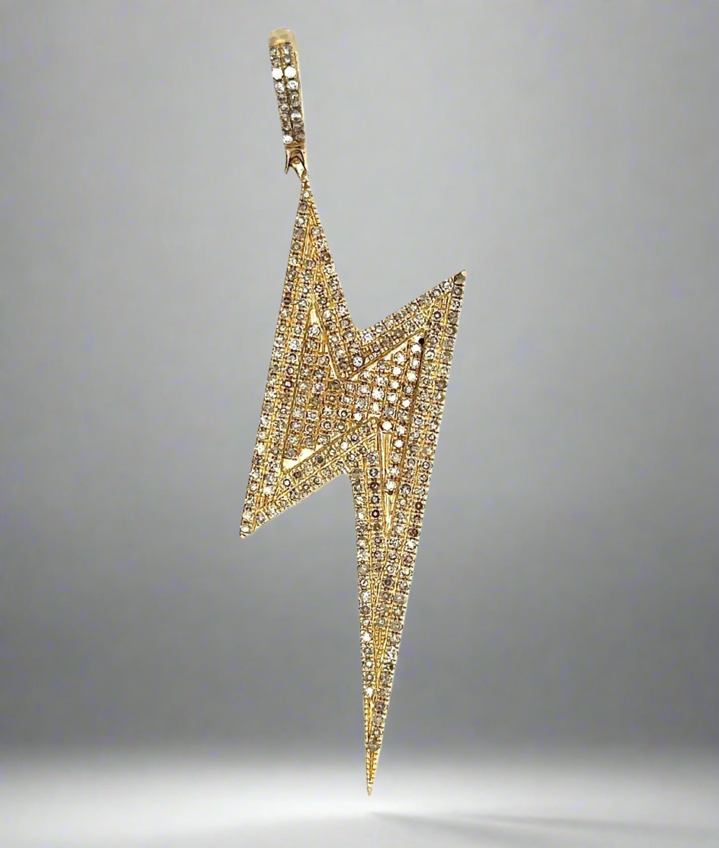 Diamond thunderbolt pendant with small round yellow diamonds and small white diamonds on the bail