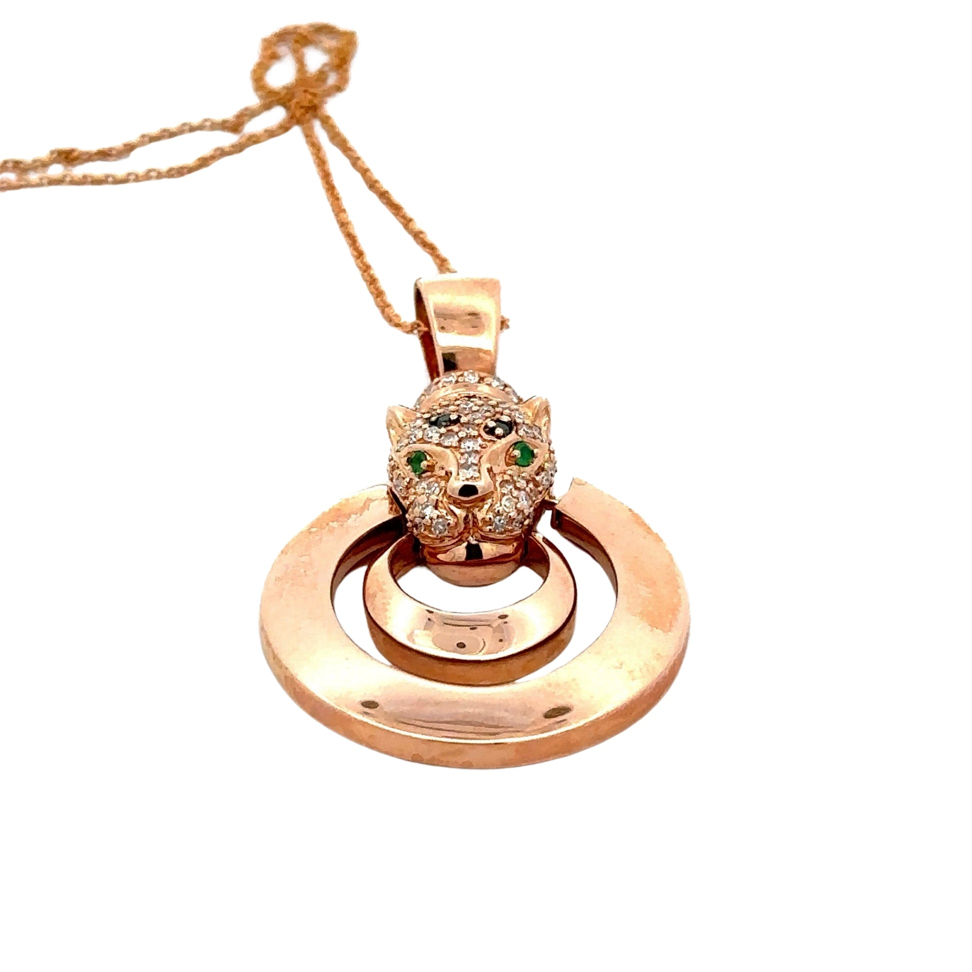 Bottom of rose gold pendant with diamond panther head and 2 emerald gemstones for eyes