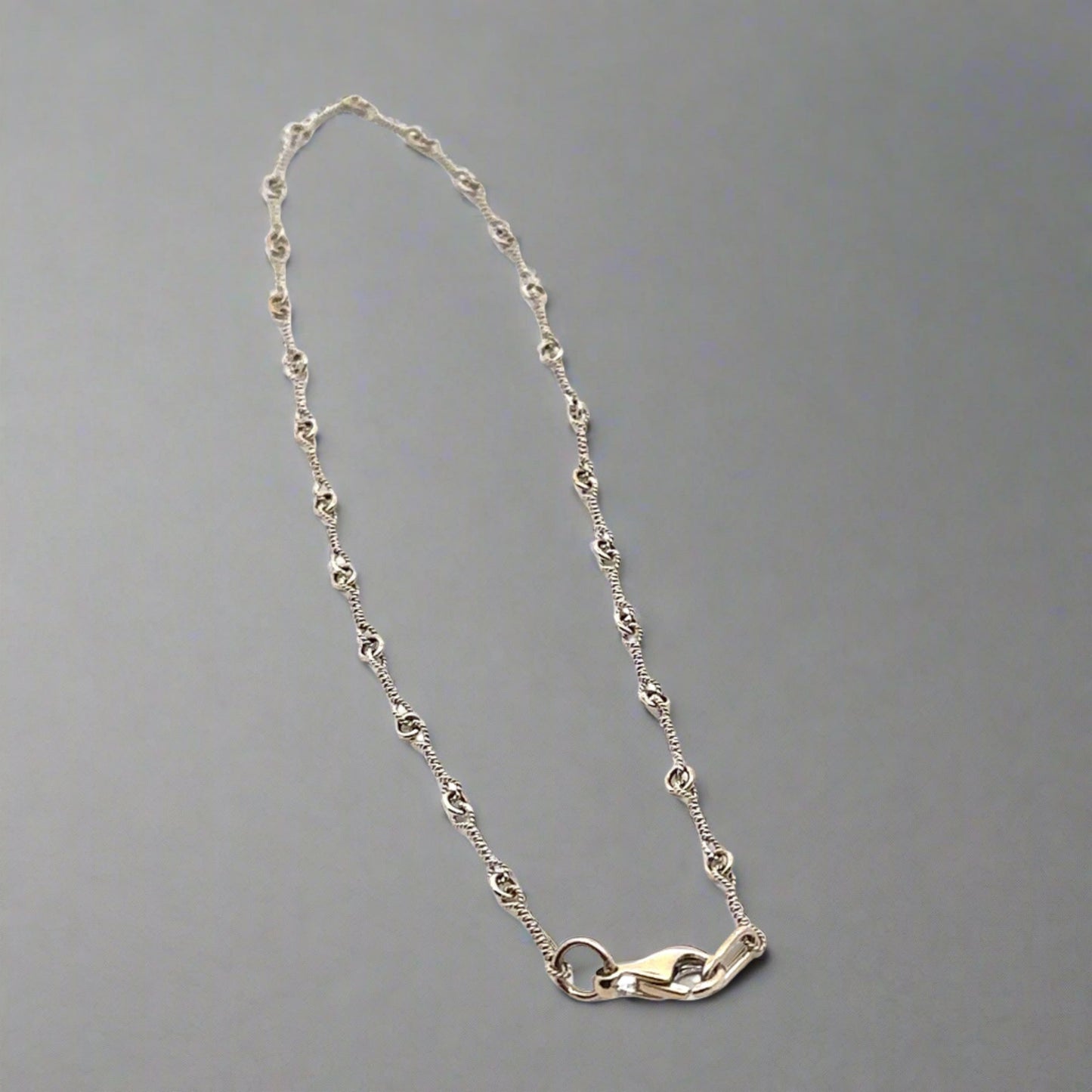 white gold anklet with knot detailing