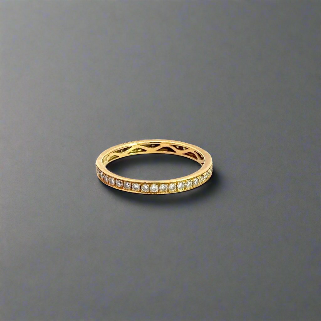 Side of yellow gold ring with small round diamonds.