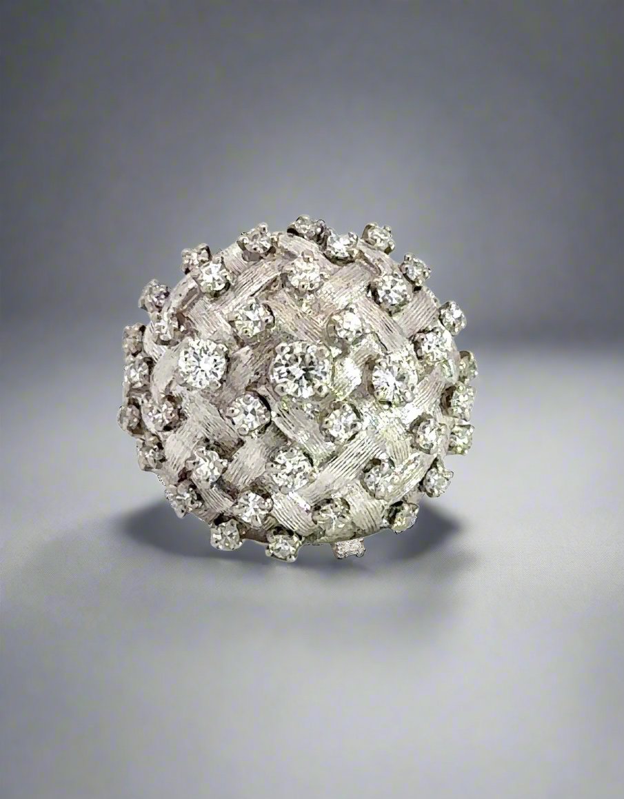 White gold diamond dome-shaped ring with different size round diamonds scattered on the dome