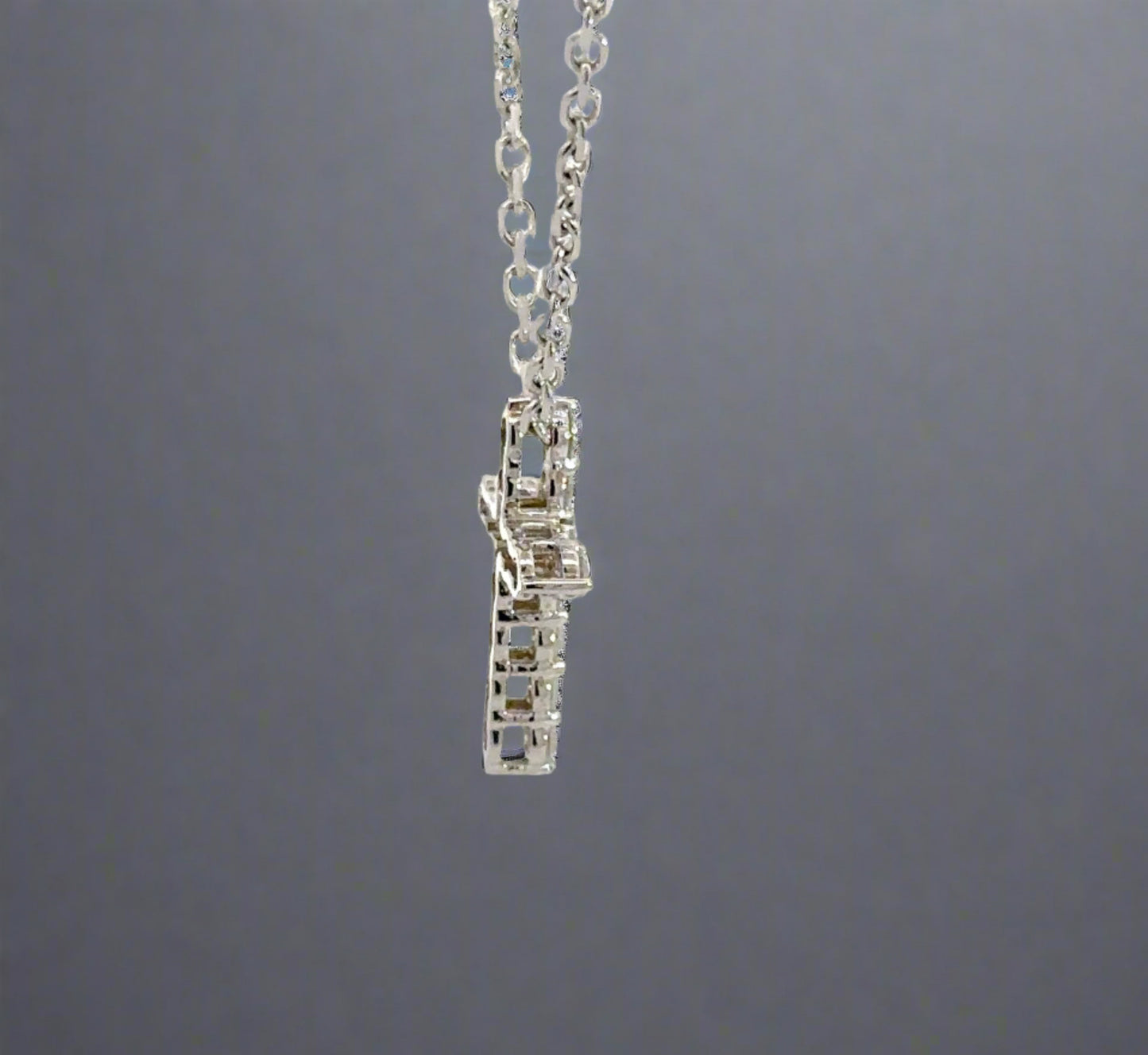 Side of white gold diamond cross with open back