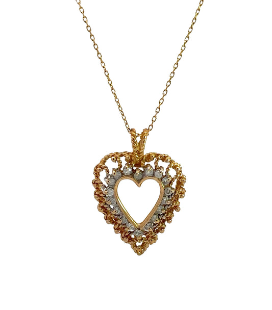 Diamond heart necklace on thin yellow gold chain with diamonds and gold in the heart outline