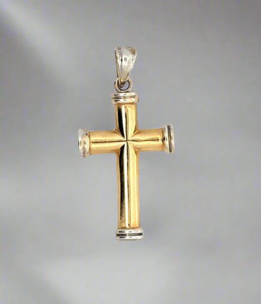 Front of yellow and white gold cross pendant with yellow gold cross and white gold border on top, bottom, and sides and white gold bail. Scratches on gold